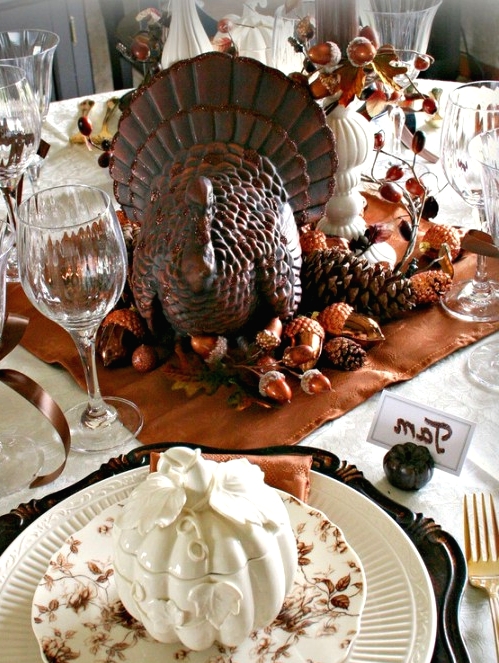 white patterned plates and a leaf and flower printed plate on top for a beautiful vintage rustic Thanksgiving tablescape