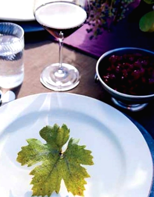 a lovely white round plate accented with a single fall leaf for a very modern and fresh Thanksgiving tablescape