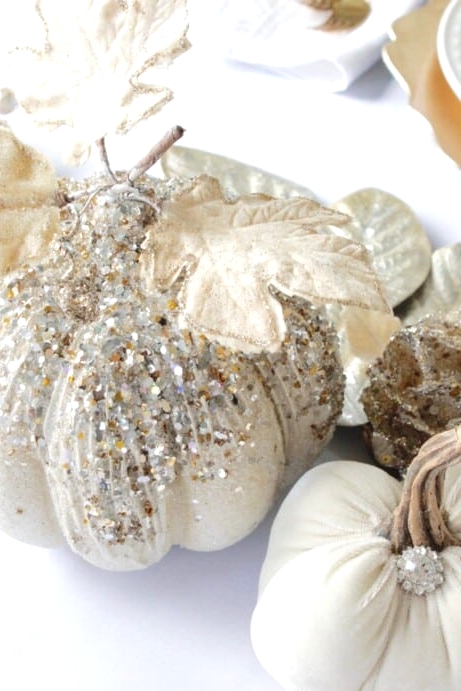glam Thanksgiving pumpkins decorated with pearls and sequins, with gilded leaves and brooches is a lovely idea for fall, too
