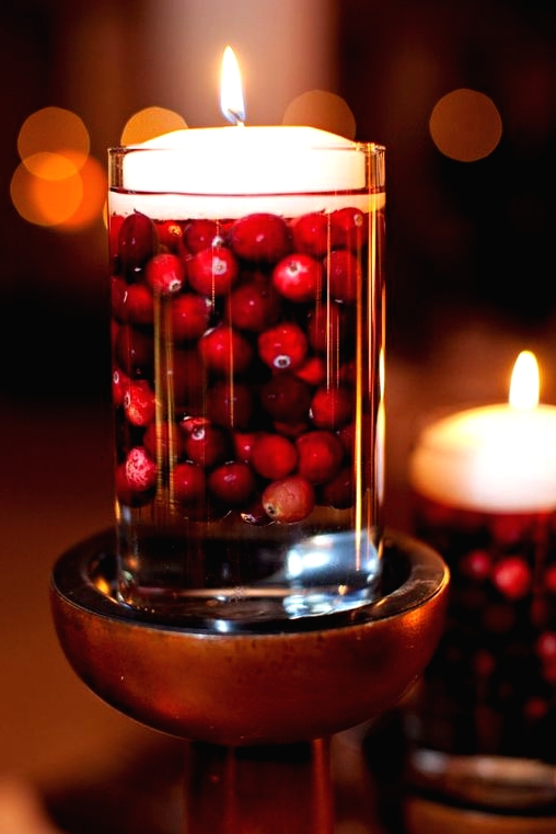 a glass with cranberries and a floating candle on top will make your Thanksgiving or Christmas cooler and cozier