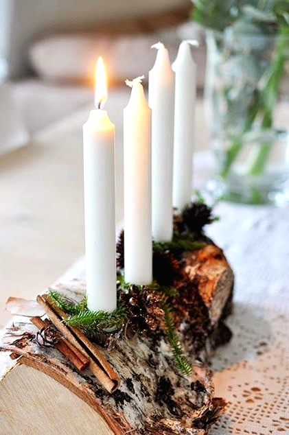 a pretty woodland candelabra of a tree stump, evergreens and cinnamon and some candles is a gorgeous idea for both fall and winter decor