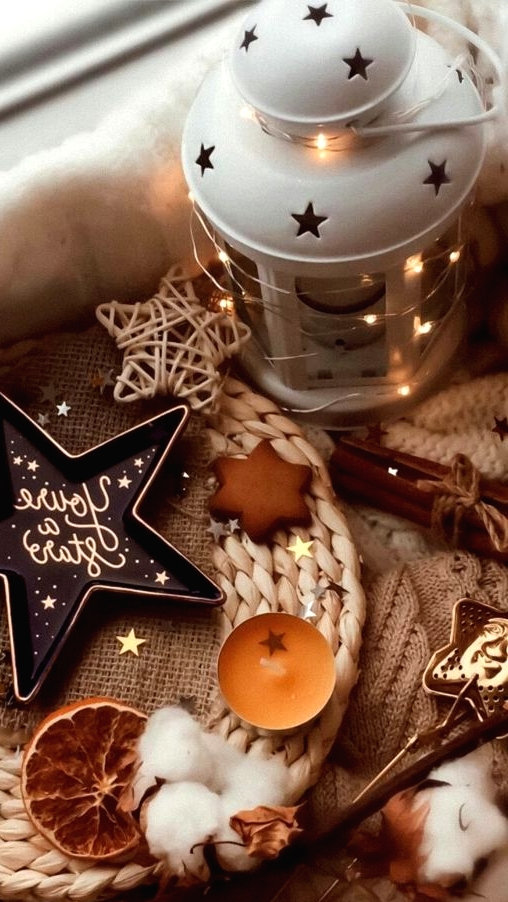 beautiful fall or Thanksgiving decor with a star lantern, star cookies and a dish, cotton, candles and dried citrus slices