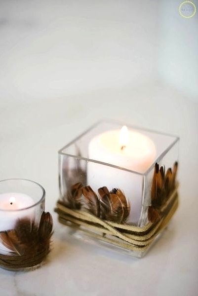 candles in glasses wrapped with feathers and leather cord will easily give your fall or Thanksgiving a boho feel