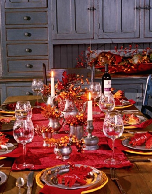 a bold burgundy Thanksgiving tablescape with gold chargers, tall and thin candles, berries and leaves for a vintage Thanksgiving tablescape