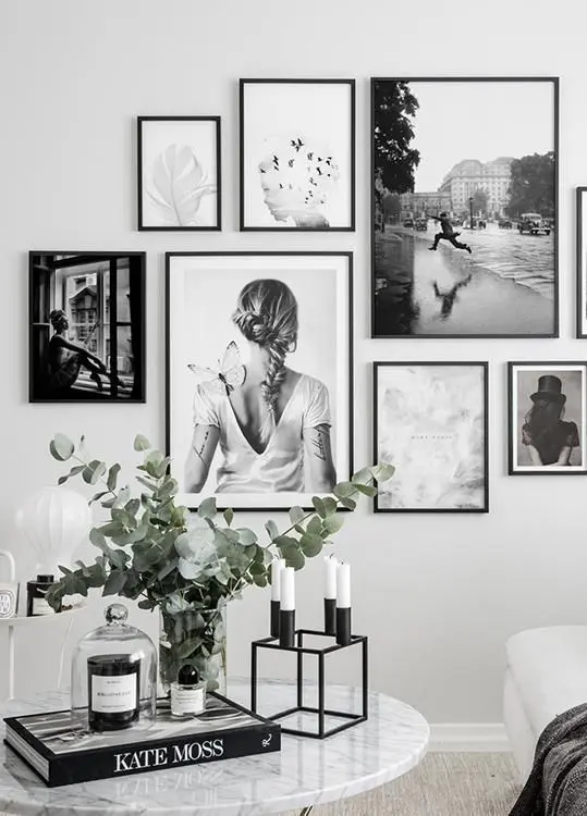 a black and white free form gallery wall with no matting and thin black frames is a cool and stylish solution