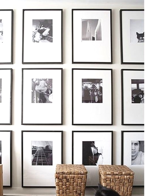 a grid black and white gallery wall made eye-catchy with asymmetrical matting and thin black frames