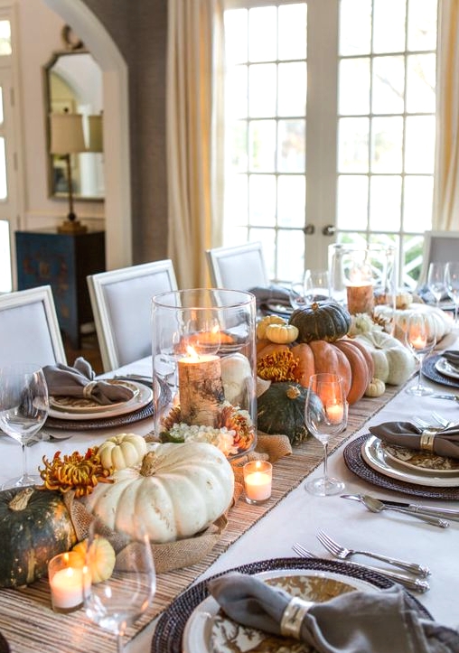 an all-natural Thanksgiving centerpiece of lots of heirloom pumpkins and candles is a lovely idea that requires no effort at all