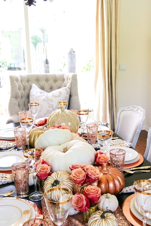 a glam Thanksgiving centerpiece of pink roses, white, copper and gold pumpkins plus a rose gold sequin table runner is a very cute idea
