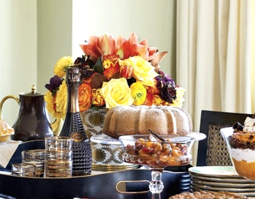 a bold Thanksgiving centerpiece of bright yellow and orange blooms and some dark ones is a lovely idea for the fall