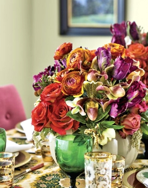 a bold Thanksgiving centerpiece of purple, orange and red blooms and greenery is a refined solution for a bright and exquisite party