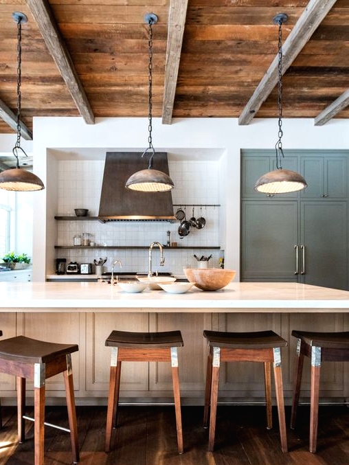 a rustic kitchen with light-stained cabinetry, open shelving, built-in storage furniture, rich-stained stools and a reclaimed wood ceiling