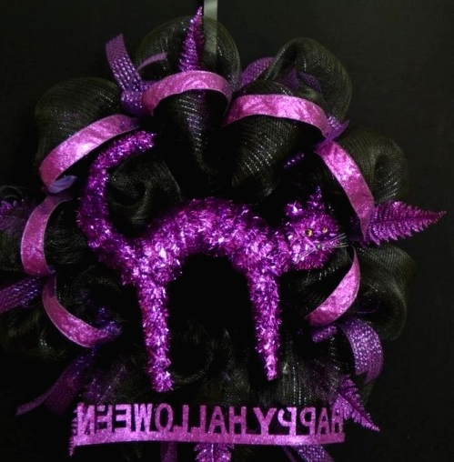 a black mesh wreath with purple ribbons and purple glitter horns plus some words is a lovely idea for Halloween decor and it will add a glam touch to the space