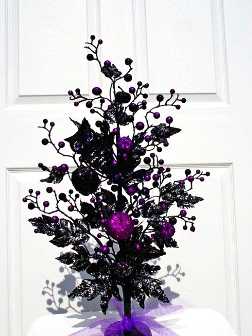 a black tree with purple berries and pomgranates, black butterflies is a creative and bold decoration for Halloween