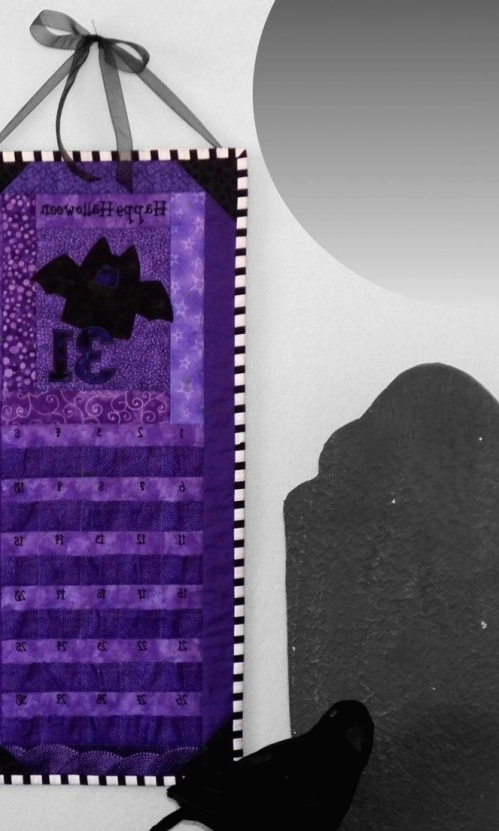a black and purple calendar and a blackbird for Halloween decor are an easy and cool idea to rock