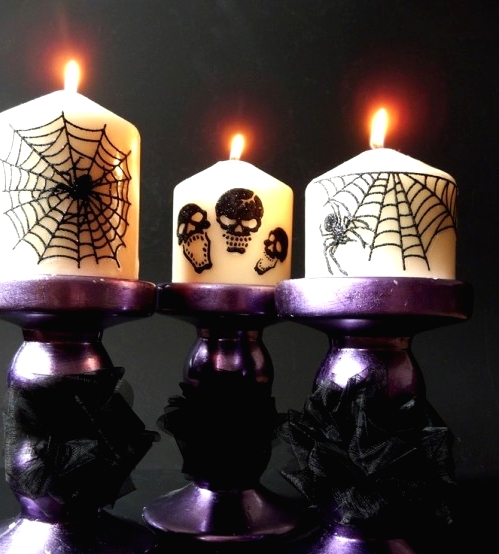 purple candleholders, neutral candles with spiderwebs and skulls painted on them are amazing for Halloween styling