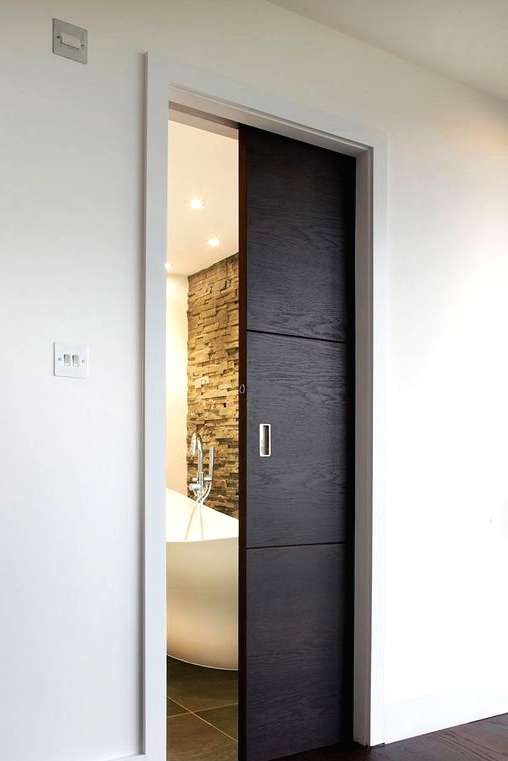 a small dark-stained pocket doors leads to the bathroom and makes it look like a treasure