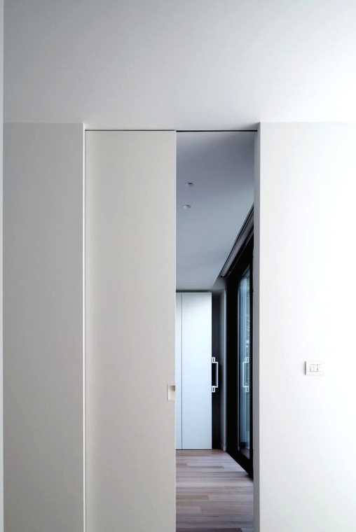 a white pocket door looks very sleek and chic and doesn't stand out from the rest of the room looking cool