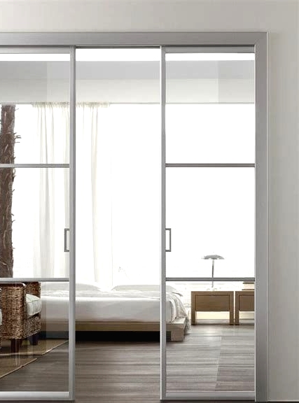 ethereal and light white white metal frame and glass pocket doors separate the bedroom from the living room in a chic way