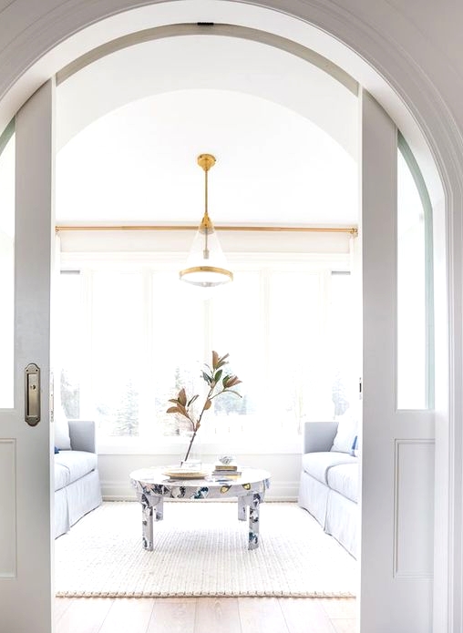 glass pocket doors for an arched doorway is a stylish idea to separate the spaces and make it with interest