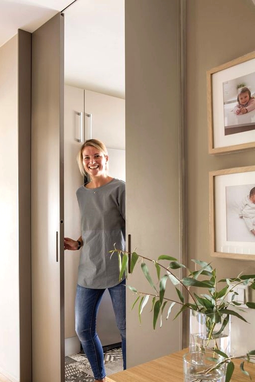 sleek and chic dove grey pocket doors wiht little handles are ideal to delicately separate the spaces without stealing room