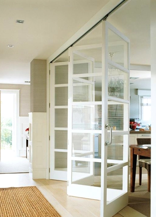 glass and white wood folding doors look very lightweight and ethereal, they subtly divide the spaces and look neutral and calming