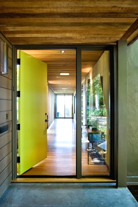a neon yellow metal front door plus a window is a cool idea for a modern or contemporary home, and its color is amazing