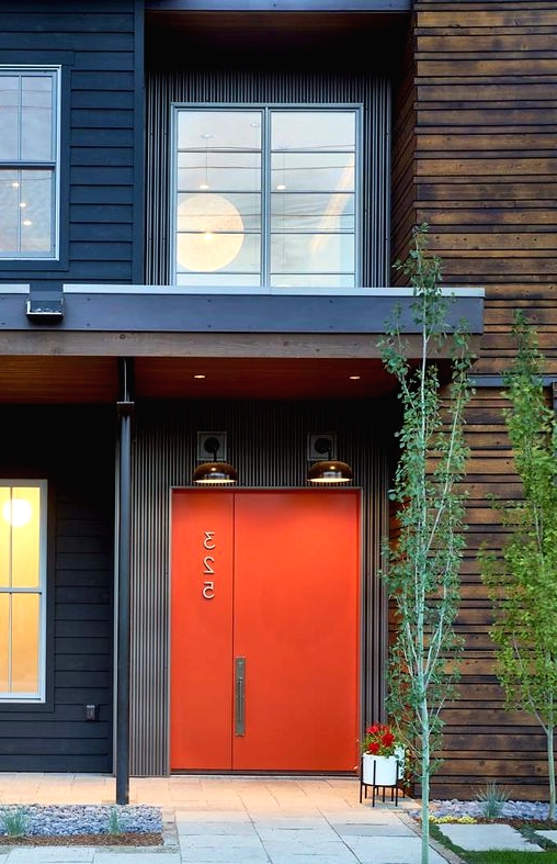 a stylish modern orange metal front door with a house number is an ultimate solution for a mid-century modern house