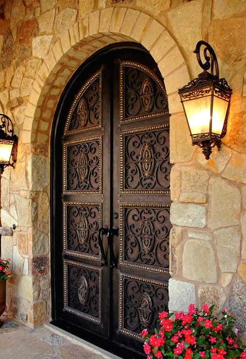 dark vintage-styled wrought iron front doors are perfect for a mansion or a large vintage house as they make a refined statement at once