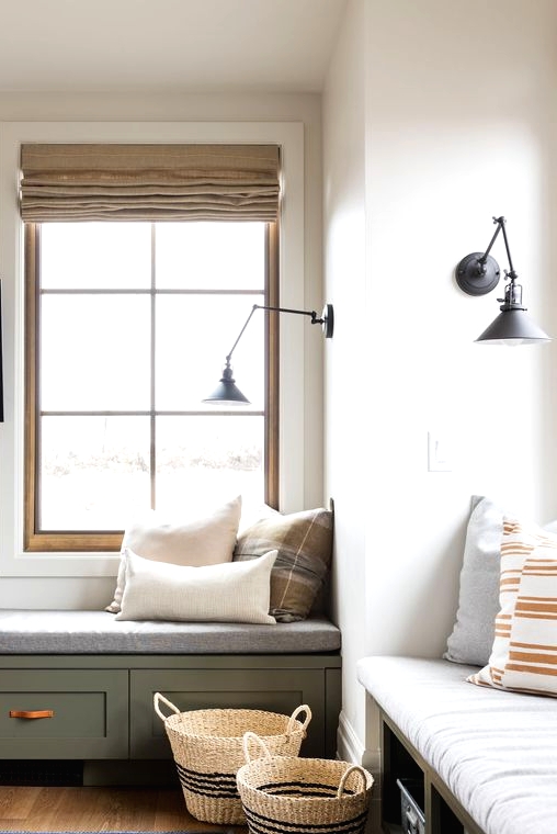 windows with built-in storage daybeds, with pillows and black sconces are amazing for reading and just enjoying the views