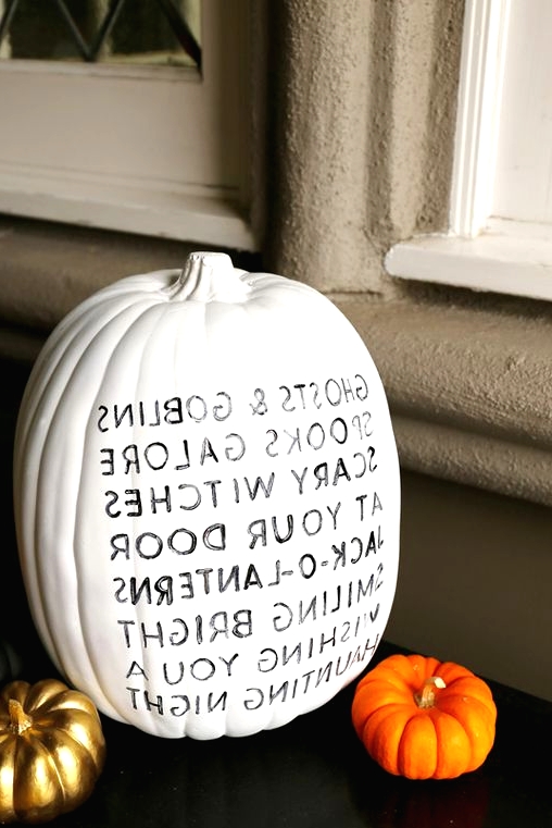 a simple white natural pumpkin decorated with a black sharpie is a very easy modern craft that you can DIY