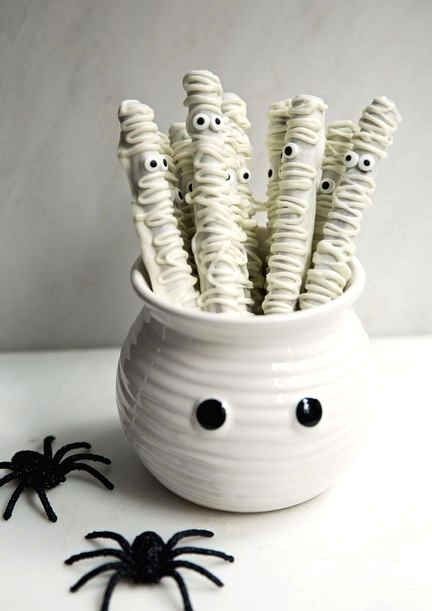 a white bowl with googly eyes and white sweets with eyes is a cool idea for a Halloween kids' party in neutrals