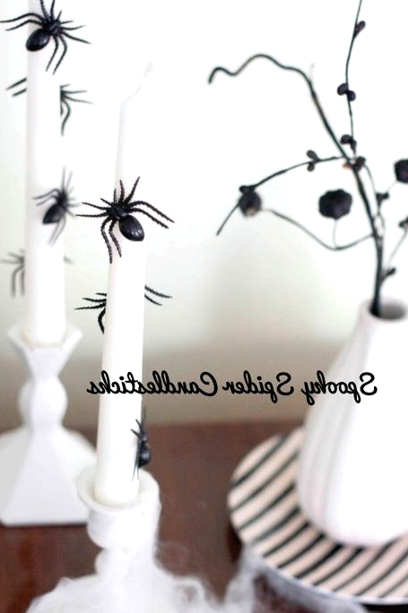 white candleholders and candlesticks decorated with black spiders are perfect for Halloween decor and are easy to make