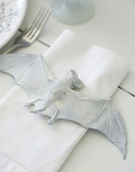 a white napkin decorated with a white bat looks scary and bold and the bat is pretty realistic, try that for your Halloween party