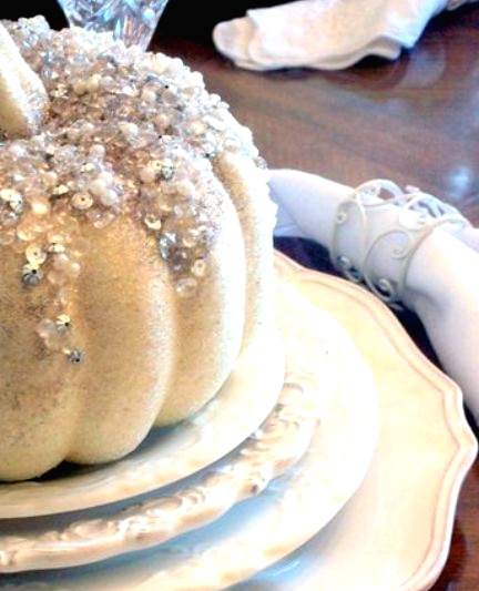 a white pumpkin with embellishments and sequins is a lovely decoration for Halloween and looks very refined