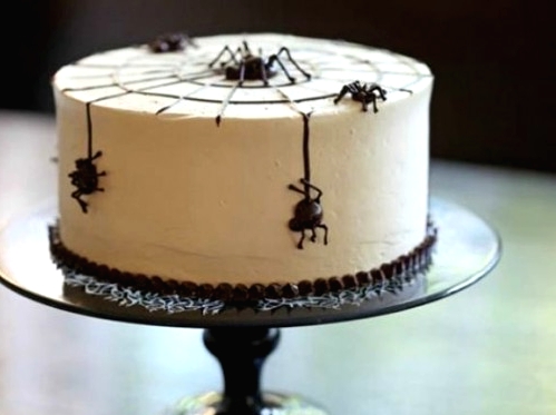a white Halloween cake decorated with black chocolate spiders is a cool solution for your white Halloween party