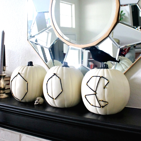 white pumpkins decorated with nails and black yarn are amazing for Halloween and such a craft won't take much time