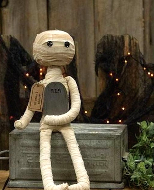 a cute and scary mini mummy decoration with a tombstone is a perfect idea for Halloween