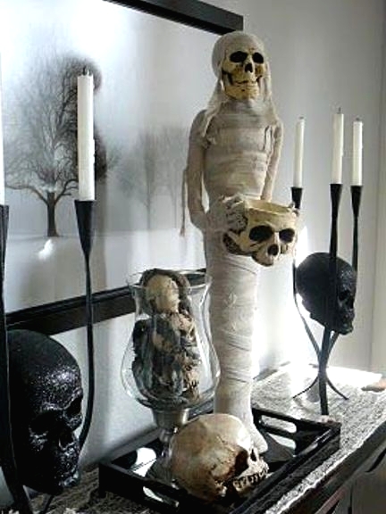 a stylish and scary Halloween decoration of a mummy, skulls and bones on a tray is a gorgeous idea to go for