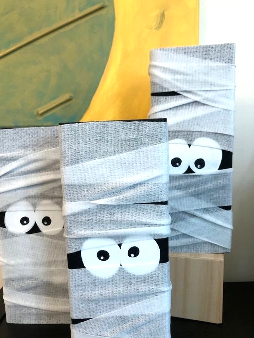 wood block Halloween mummy decorations are awesome for kids' Hallowene parties and you can DIY them easily