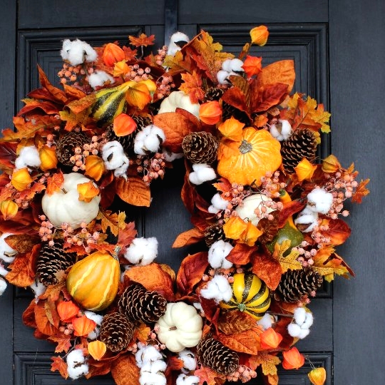 a bright Thanksgiving wreath with pinecones, gourds, pumpkins, leaves and dried blooms is a very eye-catchy solution