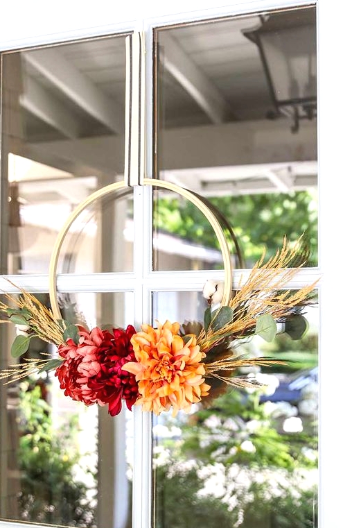such a cute and bright fall or Thanksgiving wreath with bold blooms, greenery and wheat is a very bold and easy to DIY piece