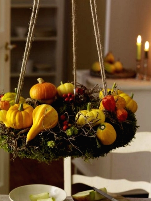 a hanging Thanksgiving wreath of moss, faux berries, twigs and gourds and pumpkins is a lovely idea for Thanksgiving