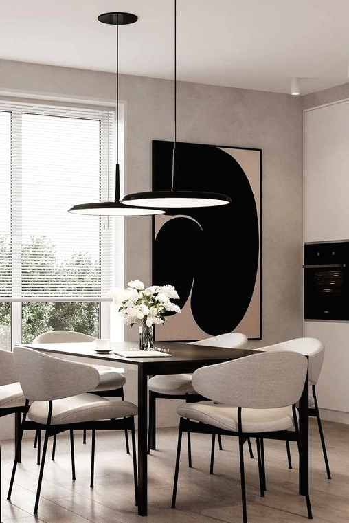a stylish greige dining room with a black table, neutral chairs, black pendant lamps, a statement artwork and a burgundy sofa is wow