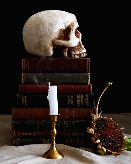 simple and elegant vintage Halloween decor with a stack of vintage books and a skull on top is amazing for your party