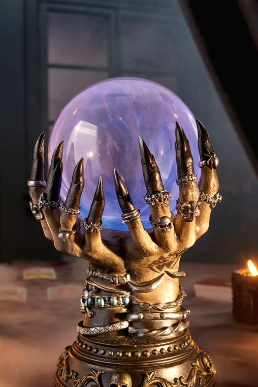 witch's hands with lots of jewelry holding a magical ball that will tell the future is a great idea for Halloween