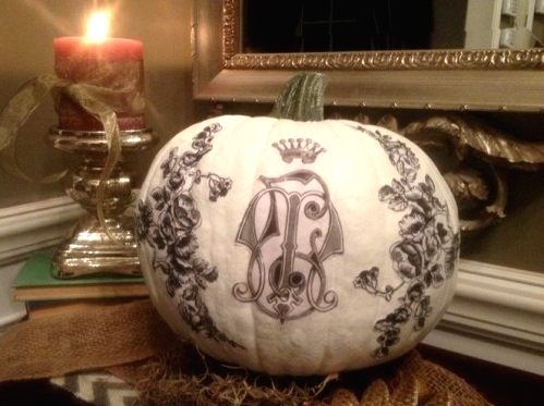 a white pumpkin with black patterns on it is a very chic and refined Halloween decoration for a chic and cool party