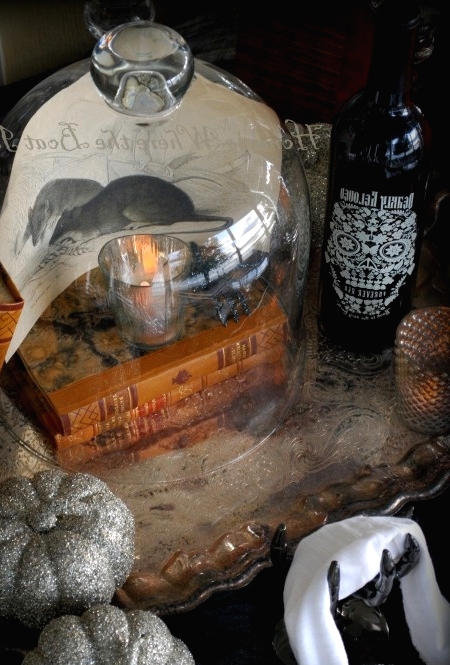 vintage books, a cloche with a candleholder, some ravens and silver pumpkins for lovely vintage Halloween decor
