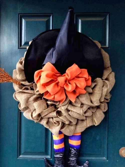 a creative Halloween wreath of burlap, a witch hat with an orange bow, witch legs and a glitter broom is a fun idea, especially for a kids' party