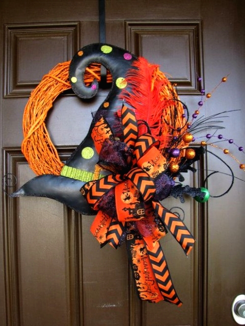 a bright Halloween wreath of orange vine, a polka dot witch hat, a bold orange bow and large beds for a colorful Halloween party