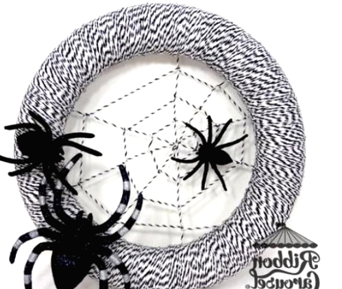 a black and white Halloween wreath with a spider net and some black spiders is a lovely idea for decorating for Halloween
